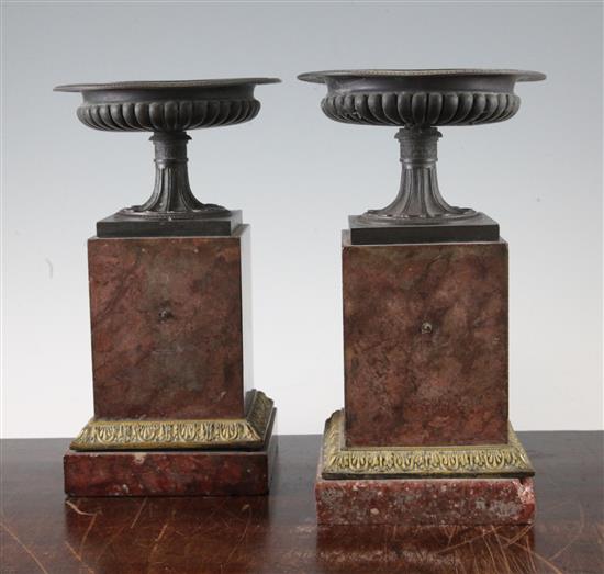 A pair of gadrooned bronze urns, 9.5in.